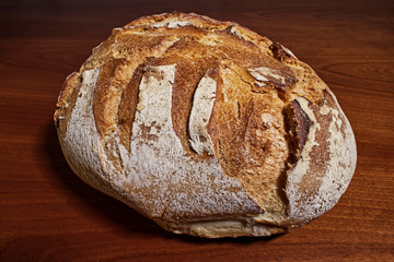 Fresh loaf of Apulian bread on wooden table. Altamura italian bread