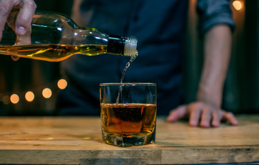 Whisky is poured into glass Beautiful bokeh
