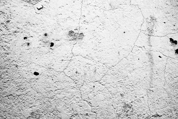 Texture of a concrete wall with cracks and scratches which can be used as a background
