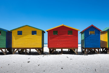 Naklejka premium The colored cabins in Muizenberg beach near Cape Town, South Africa, known for its wooden houses painted in vibrant colors