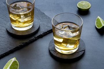 Scotch - two glasses with ice - on black background
