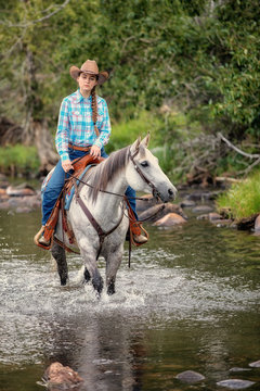 cowgirl and horse in water