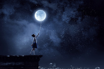 Kid girl catching moon. Mixed media - obrazy, fototapety, plakaty