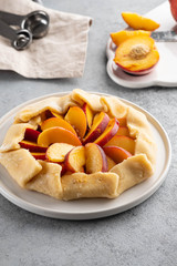 Appetite summer peach galeta on white table with copy space. summer open tart photo for cook book or food blog.