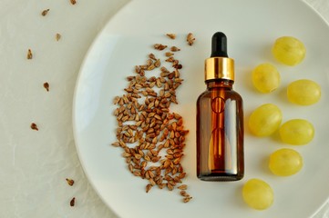 Grape seed oil in a bottle on a plate close up