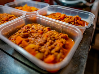 Selective close focus on homemade lentil curry in plastic containers