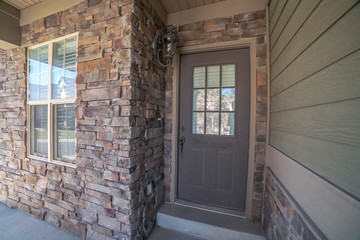 Entrance door to a house with feature brick wall