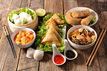 assorted of asian food, spring roll- samossa- dim sum- fried noodles