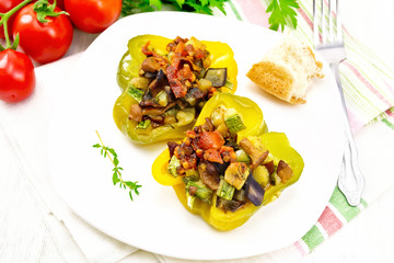 Pepper stuffed with vegetables in plate on white board