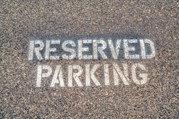 Reserved Parking sign stencilled on tarmac close up