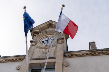 Europe Union EU and French flag on city hall with clock