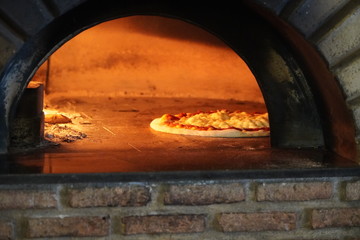 Italian pizza cooked in the oven with firewood