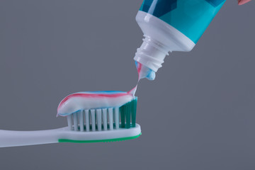 Toothbrush with colored toothpaste, care for the oral cavity and teeth, vector.