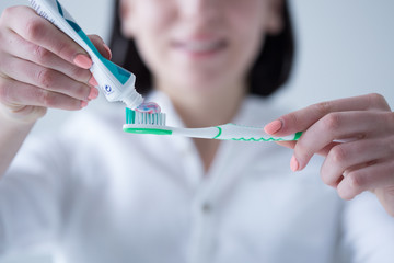 Toothbrush with colored toothpaste, care for the oral cavity and teeth, vector.