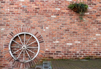 background brick wall with a wheel