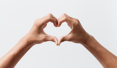 Man hands making a heart shape on a white isolated background