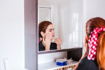 young woman with beauty face in the mirror
