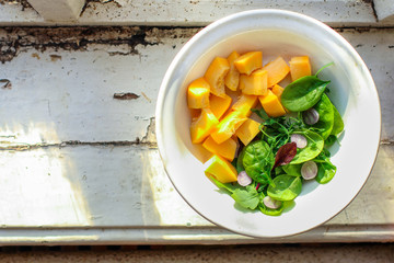 healthy salad leaves lettuce mix, pumpkin or sweet potato (healthy eating vegetables) menu concept. food background. top view. copy space