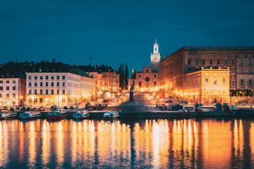 Fototapeta na wymiar Stockholm, Sweden. Scenic Famous View Of Embankment In Old Town Of Stockholm In Night Lights. Great Church Or Church Of St. Nicholas And Royal Palace. Famous Popular Destination Scenic Place In Light