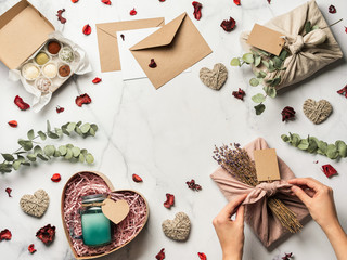 Zero waste Valentine's Day concept. Eco-friendly gift cloth wrapping in Furoshiki style, homemade...