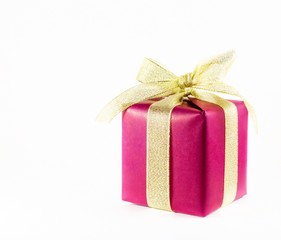 Red gift box with gold ribbon on a light background with space for text.
