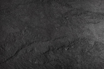 Dark gray black slate background or texture of natural stone. Black board for serving close-up © kseniaso