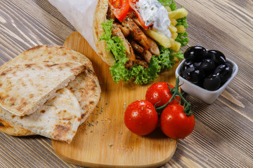 Armenian Shawarma Bread, Tomatos and Olives in a wooden background