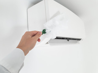 Modern airconditioner unit service - cleaning the housing.