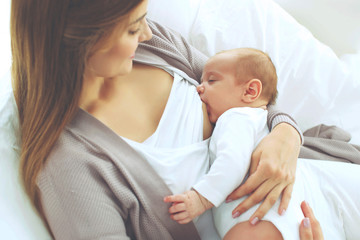 Fototapeta na wymiar A woman is breastfeeding a baby. 