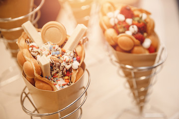 Hong kong or bubble waffle with strawberries candy ice cream on bakery shop counter in italy venice