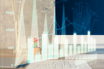 Forex graph hologram on table with computer background. Multi exposure. Concept of financial markets.