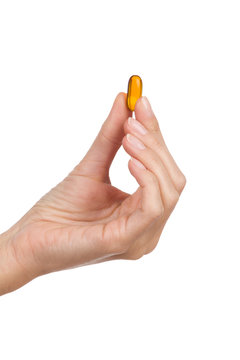 Closeup Of Woman's Hand Holding A Half Transparent Pill.