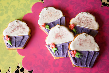 Five decorated cookies in the shape of cupcakes