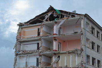 a dilapidated multi-storey building against a blue sky