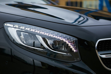 Headlight of a modern luxury car, auto detail,car care concept