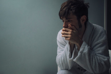 Depressed man in a dark room