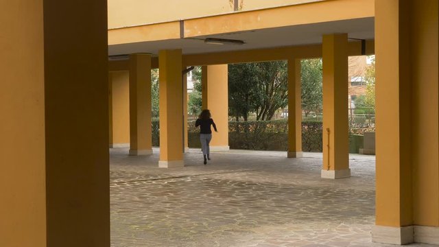 woman running in courtyard of building - pacman effect