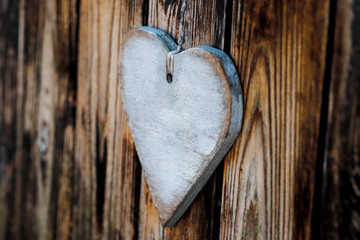 white wooden heart on wooden background