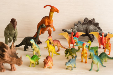 Cheboksary, Chuvashia/ Russia - June 15 2019: group of dinosaurs with children arranged on a white background © sotnikova_vera