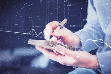 Double exposure hands with stock market chart.