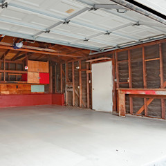 Square frame Garage doors open with a garage with wood support exposed