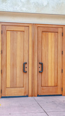 Vertical frame Closed double wooden entrance doors on cloudy day