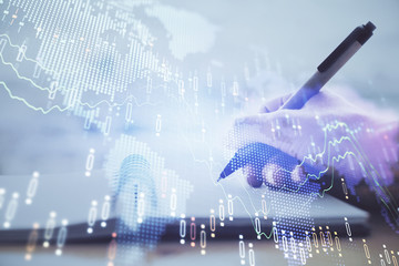 Forex graph on hand taking notes background. Concept of research. Multi exposure