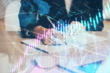 Forex graph on hand taking notes background. Concept of research. Multi exposure