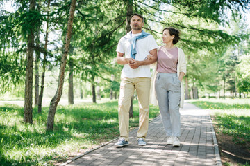 Fototapeta na wymiar Middle-aged couple walking in the park.
