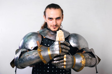 Knight with shawarma in his hands. A man in armor eats fast food. On a white background