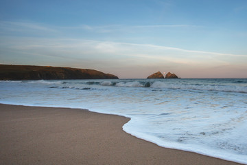 Fototapeta premium Full moon setting at Holywell Bay, Newquay, Cornwall