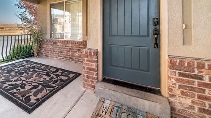 Panorama Grey door to a home with carpet on the patio