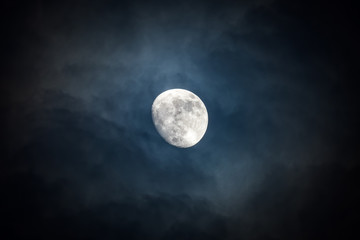 Naklejka na ściany i meble Waxing moon encircled by clouds