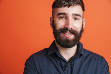 Image closeup of happy stylish man with nose jewelry smiling at camera
